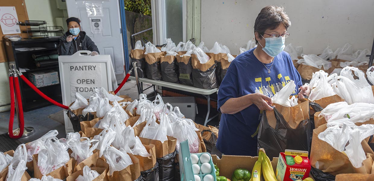 Tina Alu prepares to open the Cambridge Economic Opportunity Committee’s food pantry. Photo by Lou Jones.